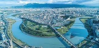 A river and bridge with Taipei City in the back